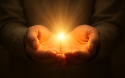 Open hands holding light, symbolizing release and healing through forgiveness